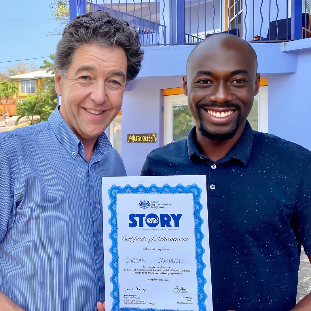 Dan Mason presenting a certificate to a journalist during training in the Caribbean